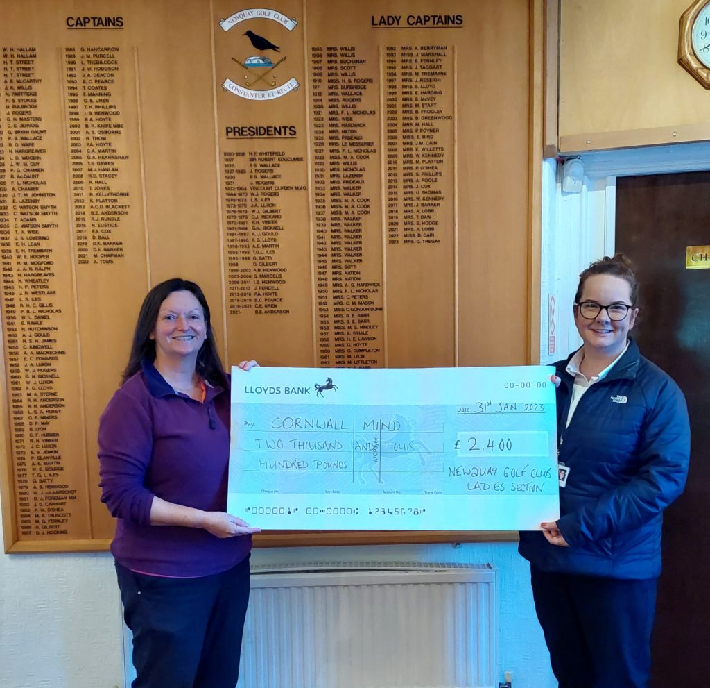 two people with a fundraising cheque