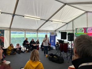 A music group taking place in a marquee.