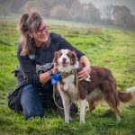 A person cuddling her dog