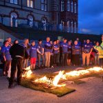 A group of people around the fire on the firewalk