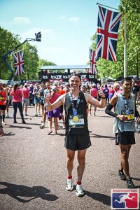A marathon runner smiling at the end of the race