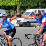 Cyclists holding hands