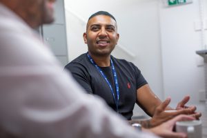 Man working for Mind talking to a person