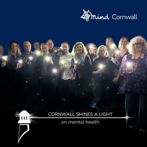 Cornwall Mind team standing with their lights on their phones.