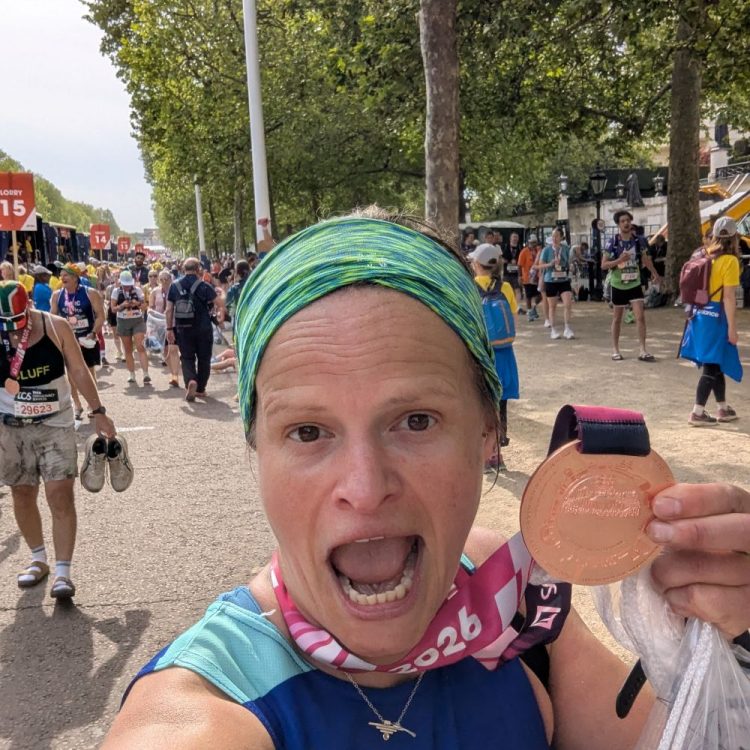One of our marathon runners holding her medal